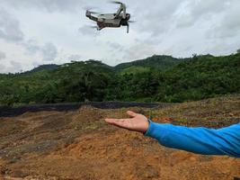 someone's hand will fly the drone photo