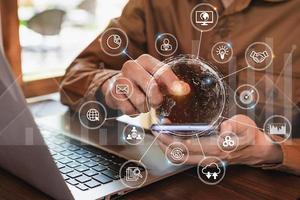 Businessman working on Desk office using smartphone and laptop with digital data and marketing graph statistics analysis icons diagram photo