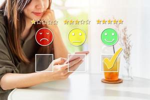 Young woman traveler using smartphone to give a five-star satisfaction rating of the food and drinks at restaurant on social media, Travel lifestyle concept photo