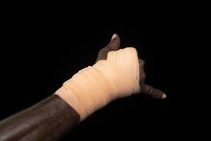 bandage hands of black Migrant detail on boat photo