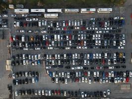 Aerial view over huge outdoor parking lots with many cars and vehicles photo