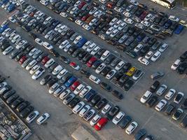 Aerial view over huge outdoor parking lots with many cars and vehicles photo