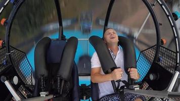 A man is riding a roller coaster. Extreme attraction flying into the sky in a capsule strapped to the ropes. photo