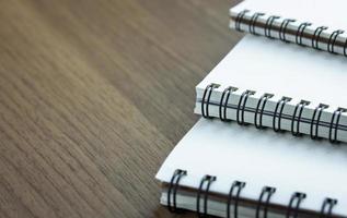 stack of spiral notebook on wood table photo