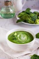 Fresh broccoli puree soup in a bowl on the table. Vegetarian food. Vertical view photo