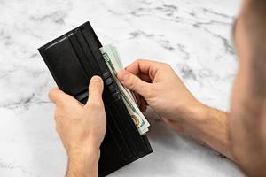 banknote money in a wallet on a light background, the concept of saving money and business growth photo