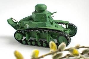 Model of an old Soviet tank made of paper on a white background. Close up. photo