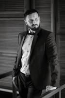 portrait of a groom with a beard in a blue suit photo