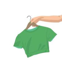 Woman's hand holding T-short on a hanger. Vector illustration.