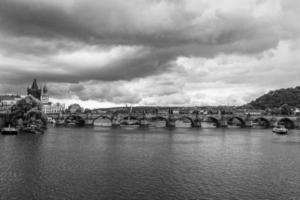 prague charles bridge view from moldova river photo