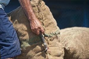 Asian male hands holding sack in a harbor photo