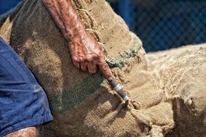 Asian male hands holding sack in a harbor photo