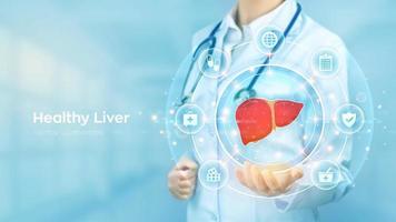 Healthy Liver. Cirrhosis and hepatitis treatment medical concept. Doctor holding in hand the hologram of Human liver and medicine icons network connection on virtual screen. Vector illustration.