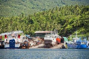 rusty rugged ship in indonesia harbor photo