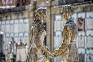 young lovers while smiling marble statue photo