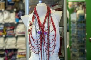 coral necklage on mannequin at the market photo