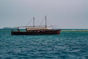 maldivian fishing fishermen boat in maldives at surise photo