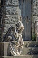 Widow marble statue outside a tomb photo