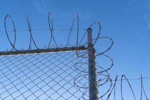barbed wire fence on blue sky photo