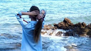 elegante donna su il roccioso mare spiaggia video