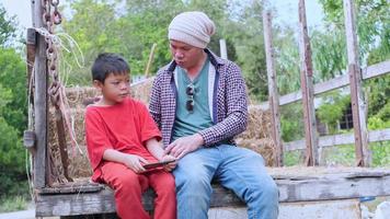 Asian boy sitting happily with father video