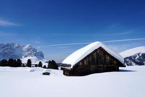 wood cabin hut in the winter snow background photo