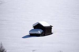 wood cabin hut in the winter snow background photo