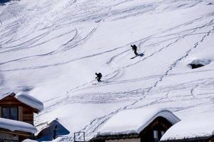 Skiers on dolomites mountain snow landscape in winter photo