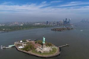 statue of liberty and new york city manhattan downtown aerial view photo