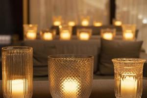 many candles lantern on a table photo