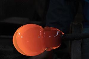 glass master while working in Murano furnace glass factory Venice Italy photo