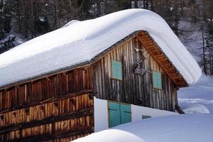 Wood cabin hut in the winter snow background photo