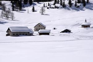 Wood cabin hut in the winter snow background photo