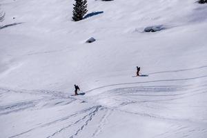 Skiers on dolomites mountain snow landscape in winter photo