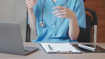 Homecare nursing service and elderly people cardiology healthcare. Close up of young hispanic female doctor nurse check mature caucasian man patient heartbeat using stethoscope during visit video