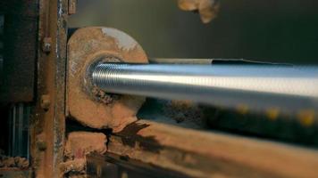 A ball screw that rotates between the screw axis and the nut on a CNC machine close-up video