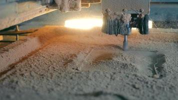 The carving of wood on a table with an automated cutting system. Close-up of a milling cutter that cuts a pattern on wood video