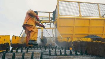 Washing large dirty agricultural machinery. Sugar beet harvesting trailer washer. video