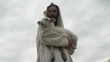 Jesus The Good Shepherd Holding A Sheep In His Arms video