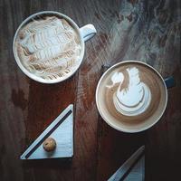 Two Cups of Coffee on a Wooden Table photo