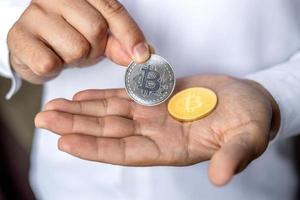 crypto exchange 2022. bitcoin money. Hand holding a coin pays money photo