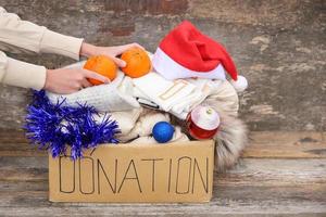 Donation box with winter clothes and with christmas decorations. Gift. photo