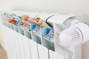 Radiator and rubles. The concept of payment for heating. photo