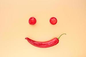 Red hot pepper with condom on a beige background. photo