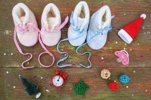 2023 new year written laces of children's shoes and pacifier on old wooden background. Top view. Flat lay. photo