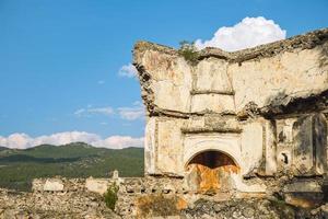 The ruins of a Greek house with the remains of a furnace in the Greek town of Karmilissos located near the village of Kayakoy, Fethiye - Turkey. Site of the ancient Greek city photo