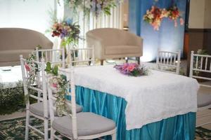 Table and Chairs in Beautiful Wedding Decoration with Flowers photo