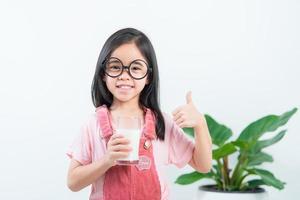 child asia girl  drink milk with a glass photo