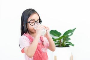 child asia girl  drink milk with a glass photo