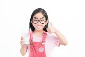 child asia girl  drink milk with a glass photo